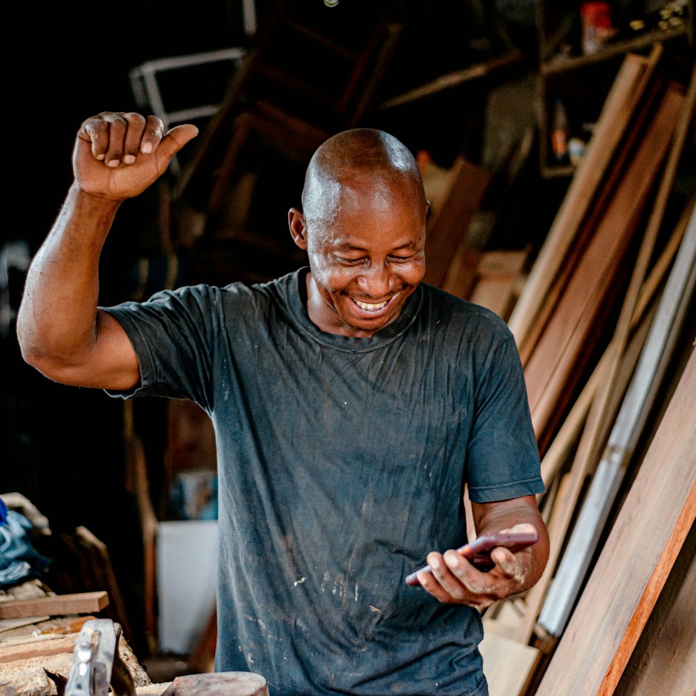 A workshop owner laughing on the phone